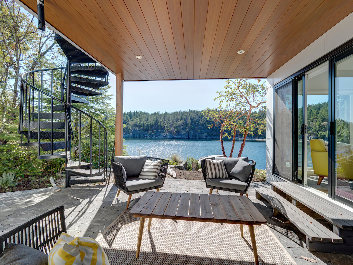 Covered cedar patio overlooking an inlet