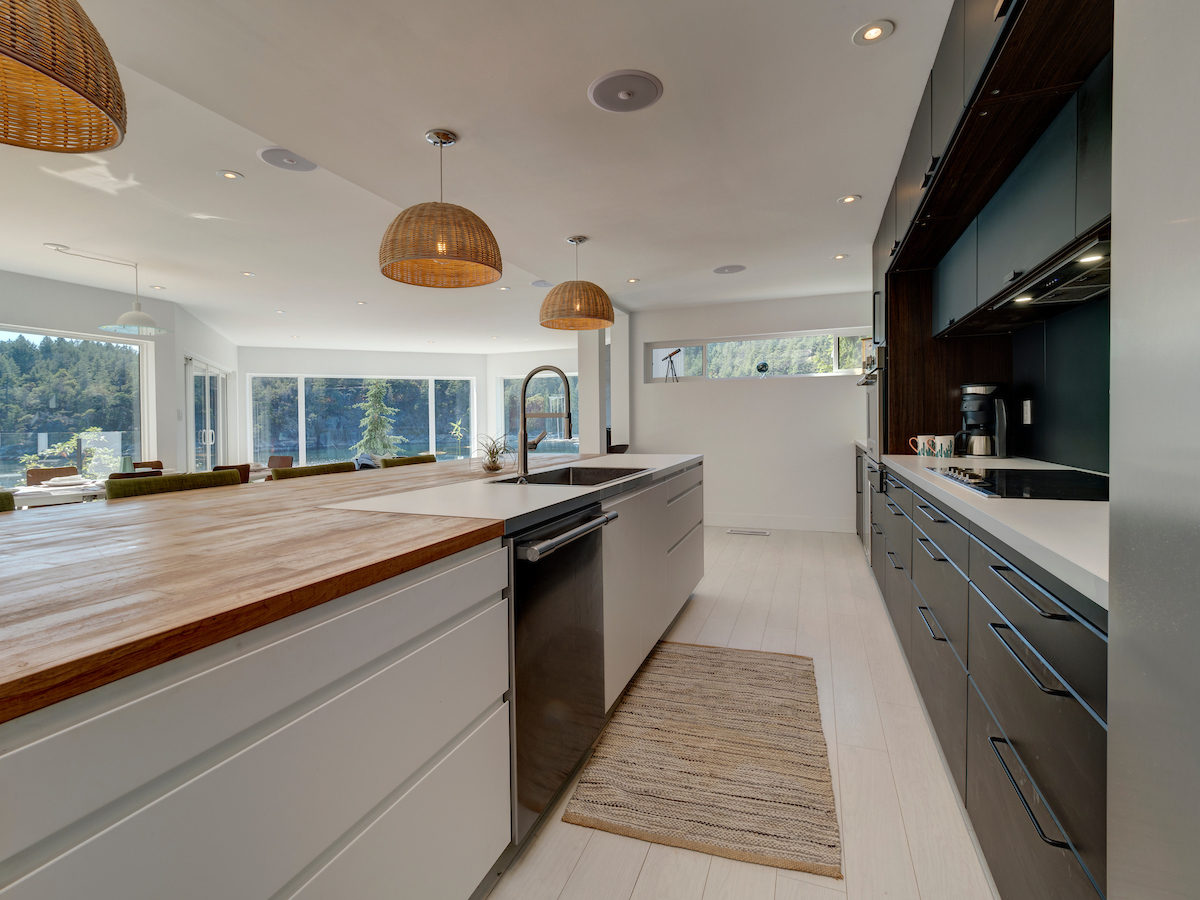 Kitchen — wide galley view with wicker pendants