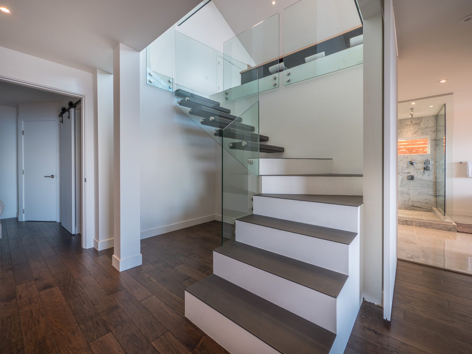 Floating staircase with glass railings — view from below
